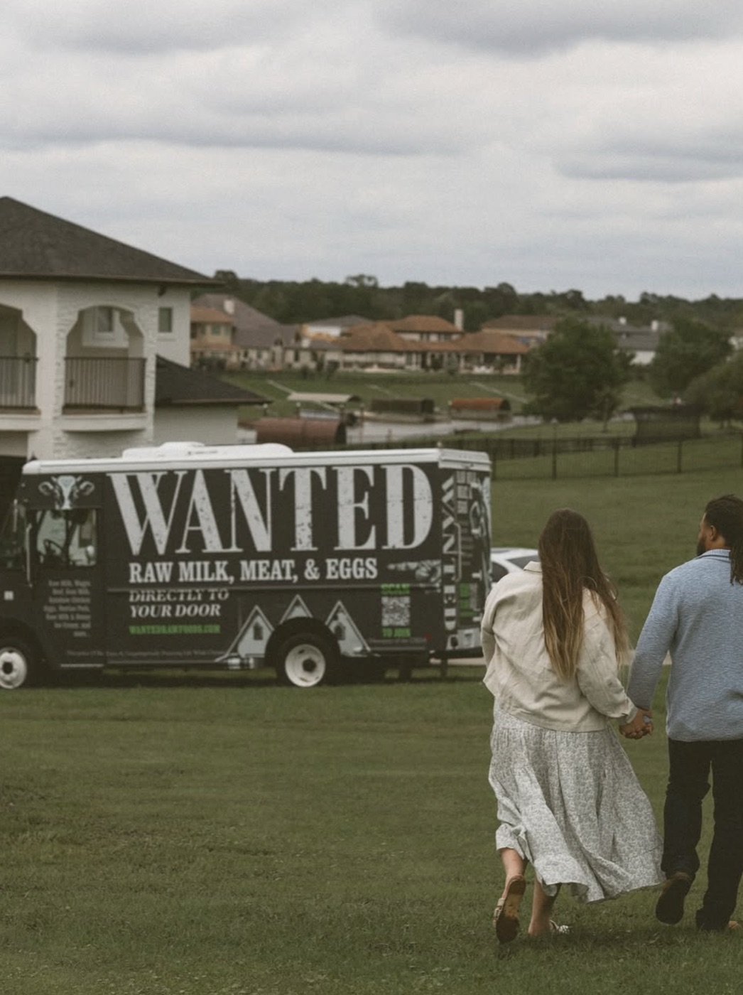 Kara and TJ walking toward the WANTED Raw Foods delivery truck